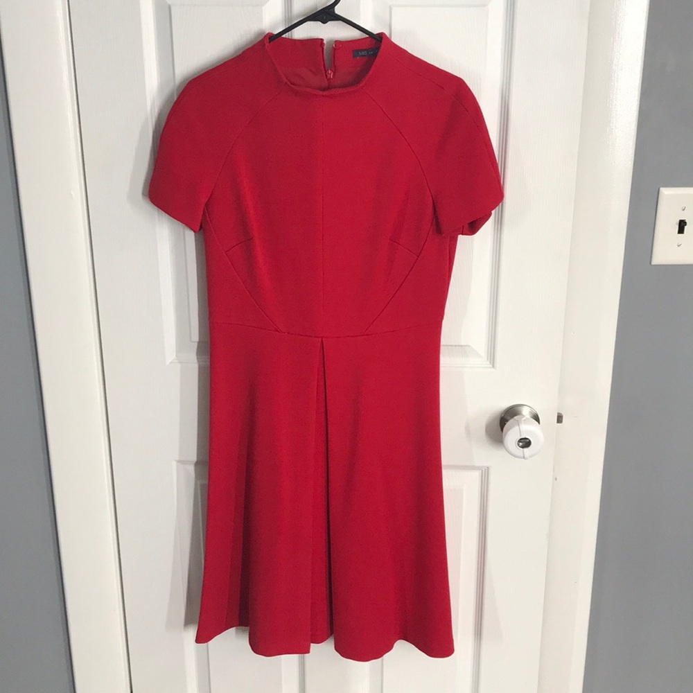 Red knee length dress w/funnel neck. A-line skirt.
